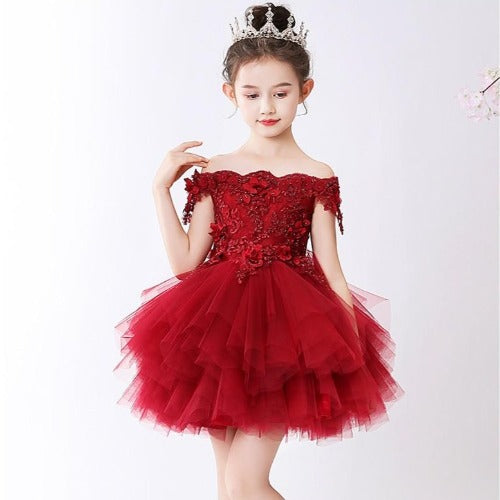 Toddler girl in a vibrant red flower applique princess tutu dress for special occasions.