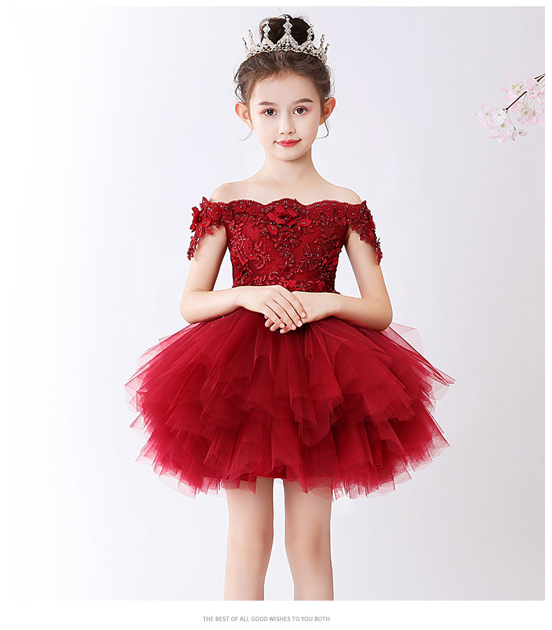 Close-up of delicate flower appliques on a red girls' tutu party dress.