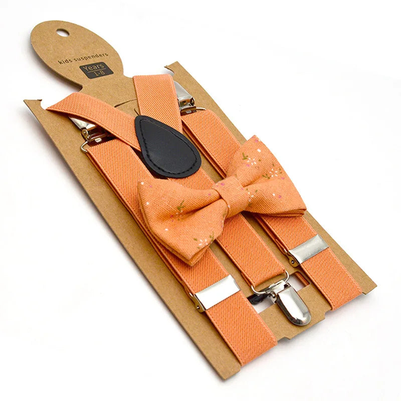 Assorted collection of colorful kids' adjustable bow tie & suspenders sets on display