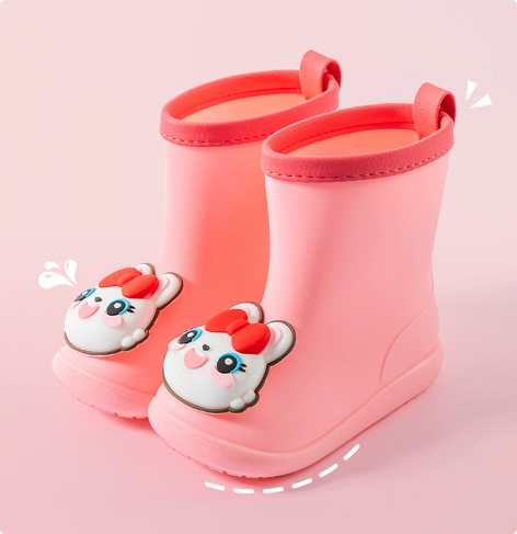 Muddy kids' waterproof lightweight rain boots being easily cleaned, demonstrating durability