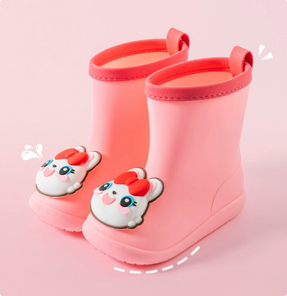 Muddy kids' waterproof lightweight rain boots being easily cleaned, demonstrating durability