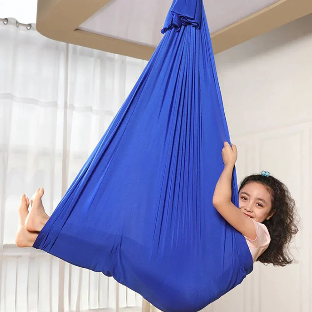 Red sensory swing pod hammock, ideal for kids calming, play, and relaxation indoors.
