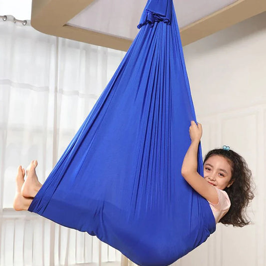 Red sensory swing pod hammock, ideal for kids calming, play, and relaxation indoors.
