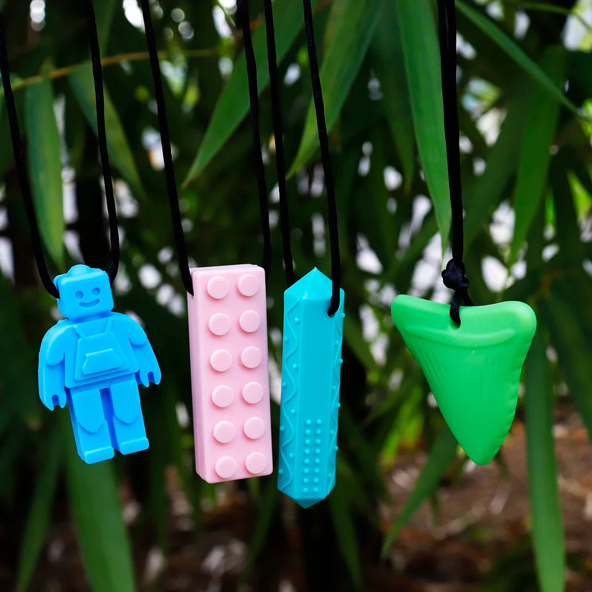 Orange chew toy necklace for kids, discreet sensory aid made from safe and soft silicone material