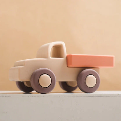 Close-up of a purple silicone bus teether, textured for soothing baby gums
