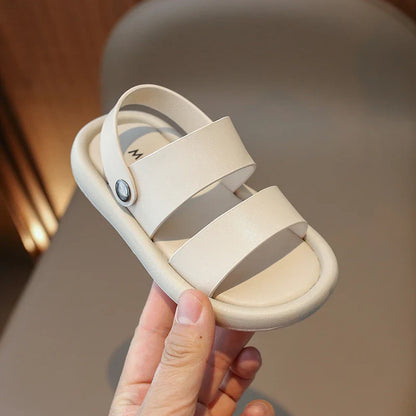 Close-up of a child's foot in a pink slip-on sport sandal, highlighting adjustable straps & breathable material.