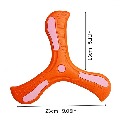 Child reaching to catch a colorful soft-grip boomerang toy in a park, promoting coordination.