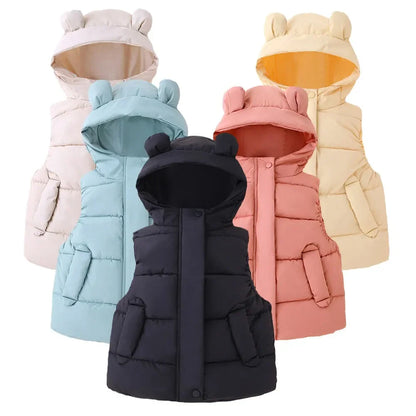 Toddler in a hooded puffer vest, enjoying outdoor play, warm kids clothing.
