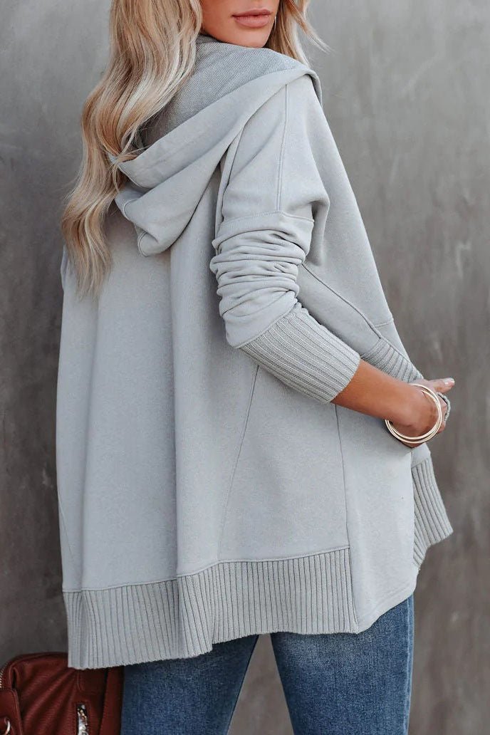 Front view: Women's relaxed longline tunic hoodie with drawstring hood & snap button closure.