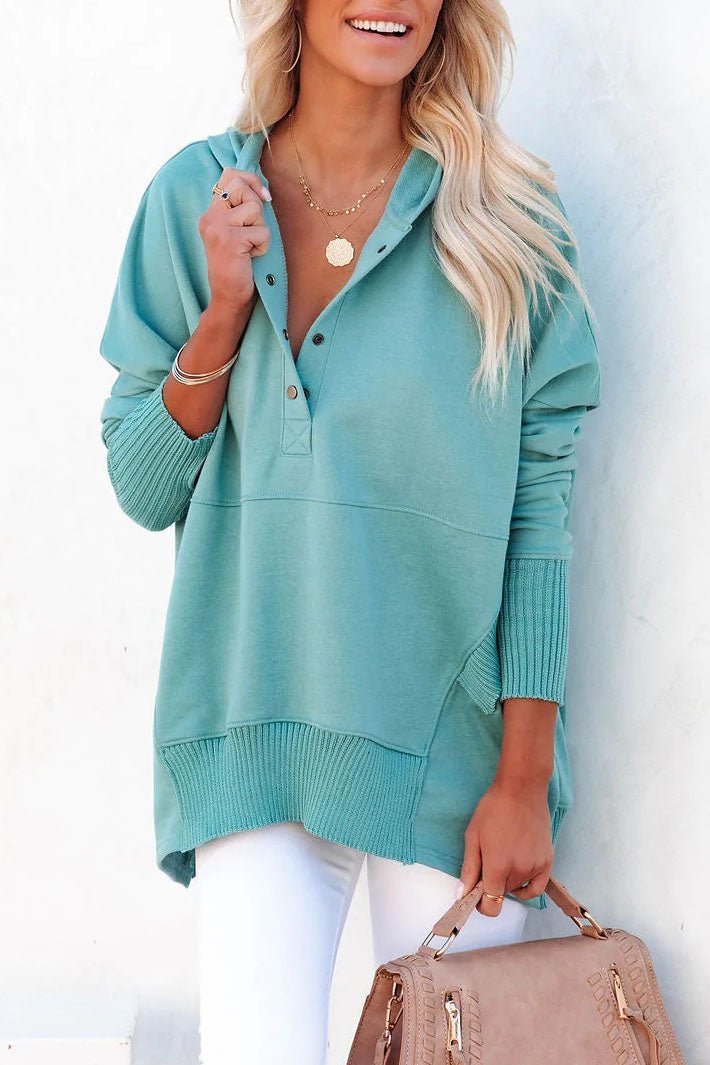 Close-up: Drawstring hood & snap buttons on women's relaxed longline tunic hoodie pullover.