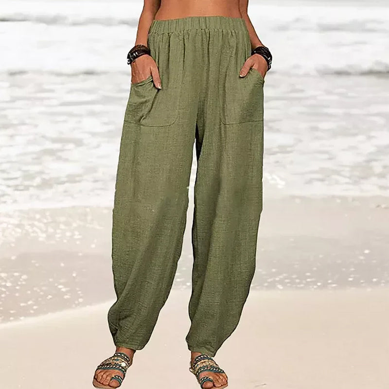 Back view of comfortable black wide-leg beach pants with an elastic waist, perfect for casual summer days.