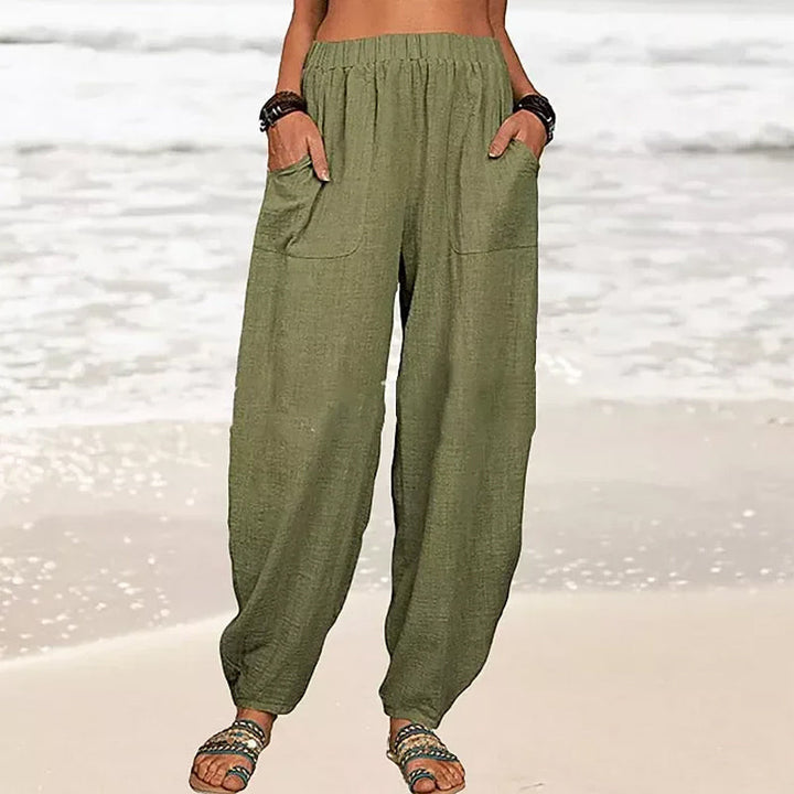 Back view of comfortable black wide-leg beach pants with an elastic waist, perfect for casual summer days.