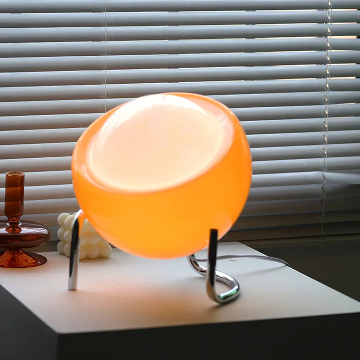Distinctive glass orb table lamp. Retro-inspired Nordic accent for contemporary spaces.