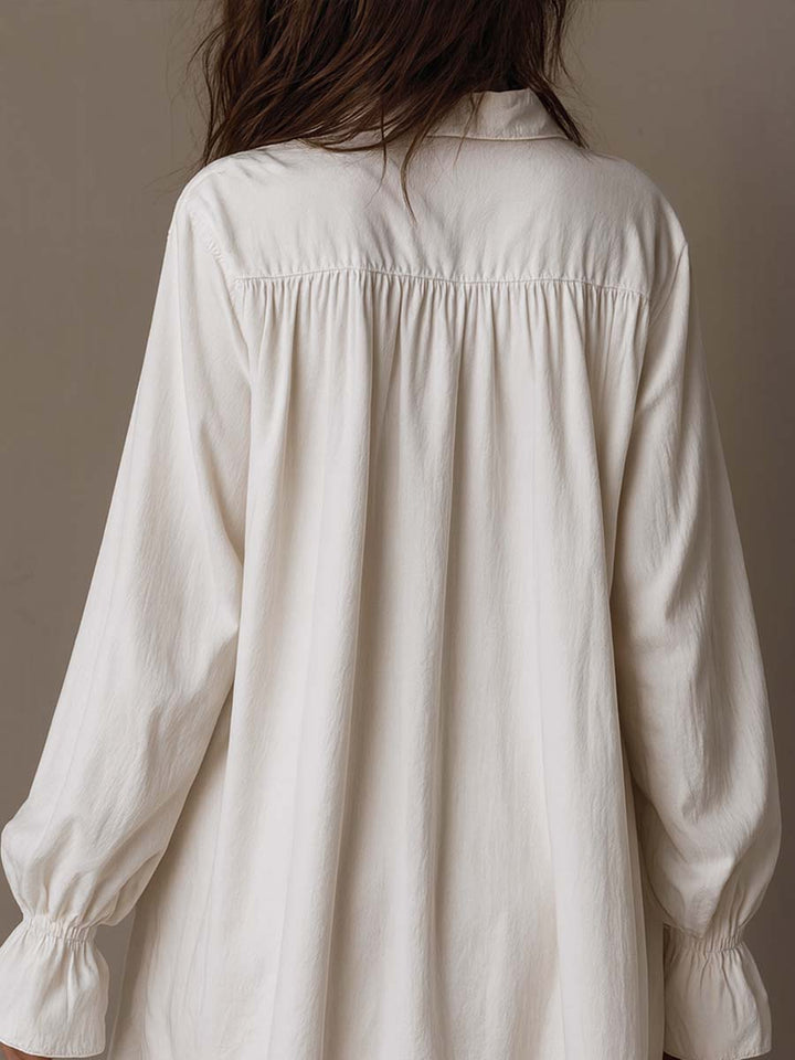 Chic women's retro white mini dress, featuring long sleeves & a stylish irregular hem. Versatile for evening or casual wear.