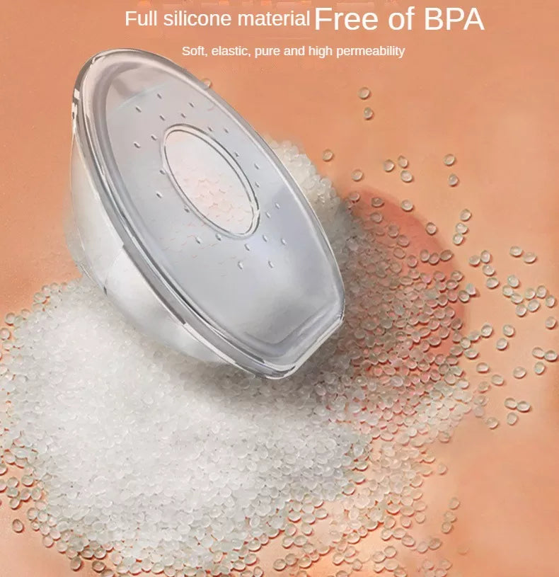 A hand holding a soft, pliable reusable silica gel breastmilk collector, BPA free
