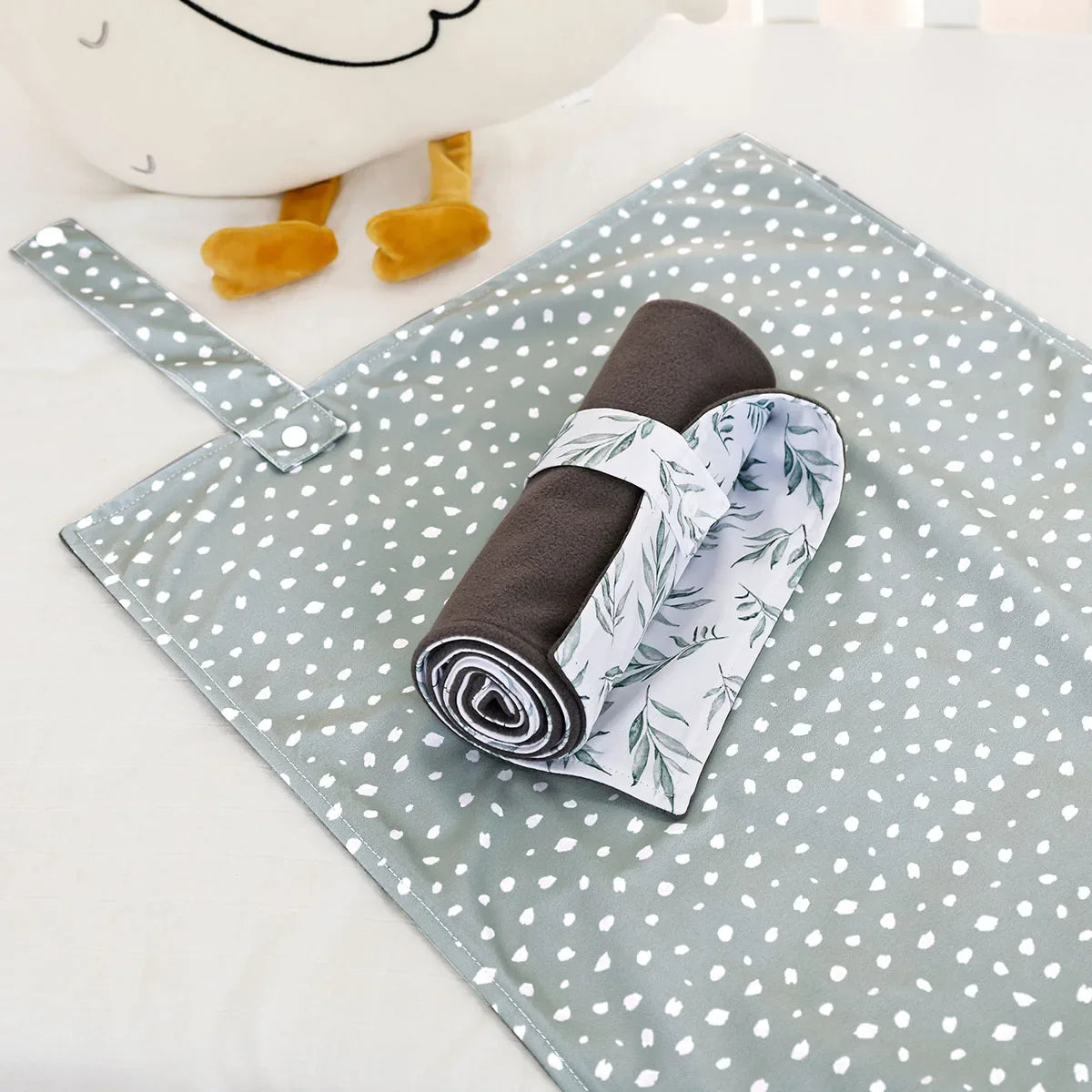 A stack of two bamboo charcoal baby changing mats, emphasizing reusability and comfort.