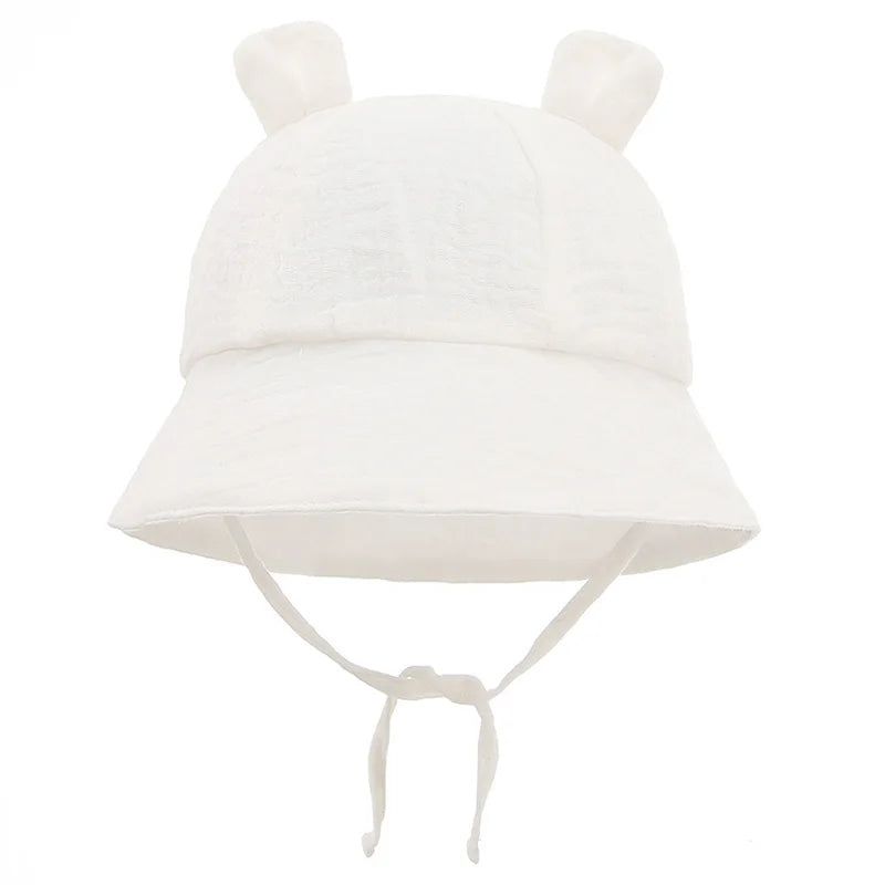 Cotton panama style baby hat, reversible, featuring a charming flower print for sun safety.