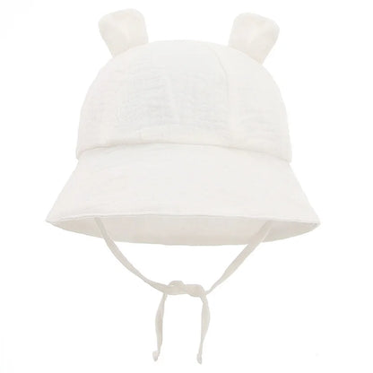 Cotton panama style baby hat, reversible, featuring a charming flower print for sun safety.