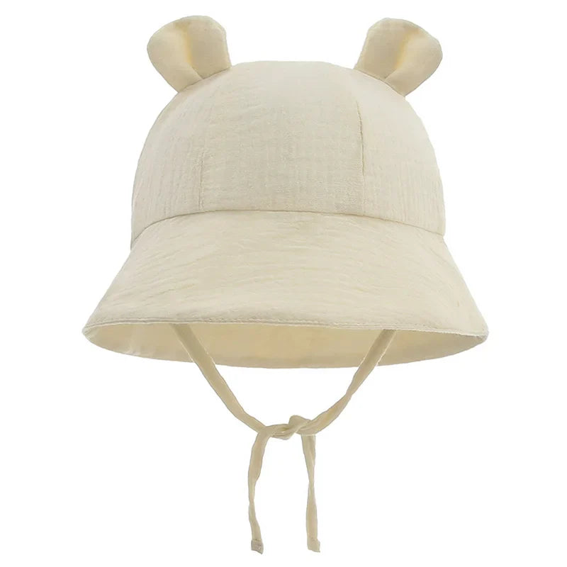 Reversible baby bucket hat, cotton and adjustable, with a colorful flower pattern.