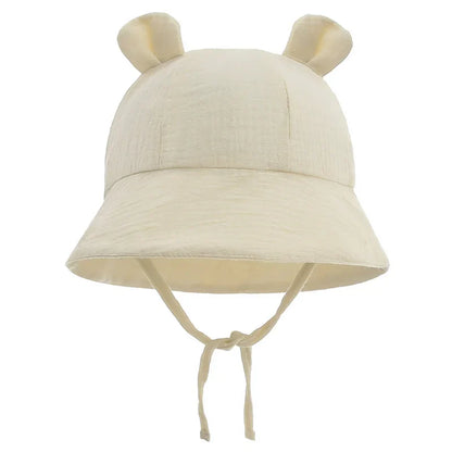 Reversible baby bucket hat, cotton and adjustable, with a colorful flower pattern.