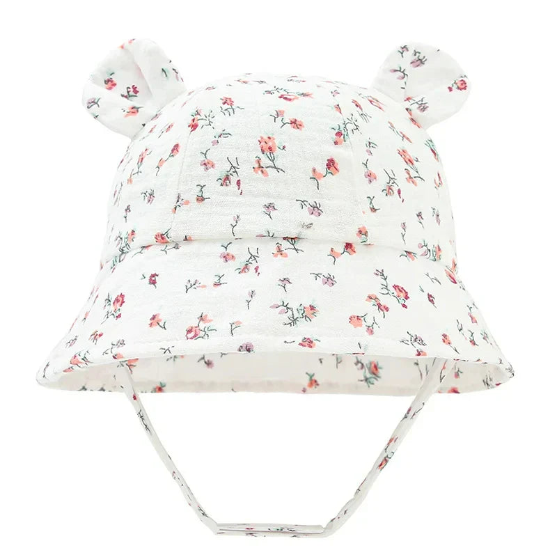 Unisex baby sun hat, cotton bucket style, reversible with khaki heart pattern.