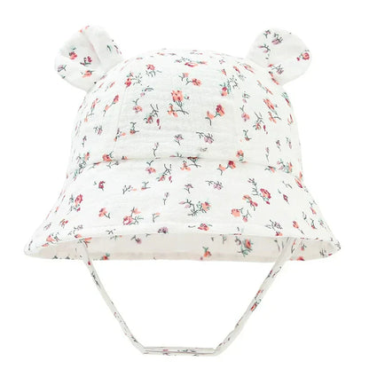 Unisex baby sun hat, cotton bucket style, reversible with khaki heart pattern.