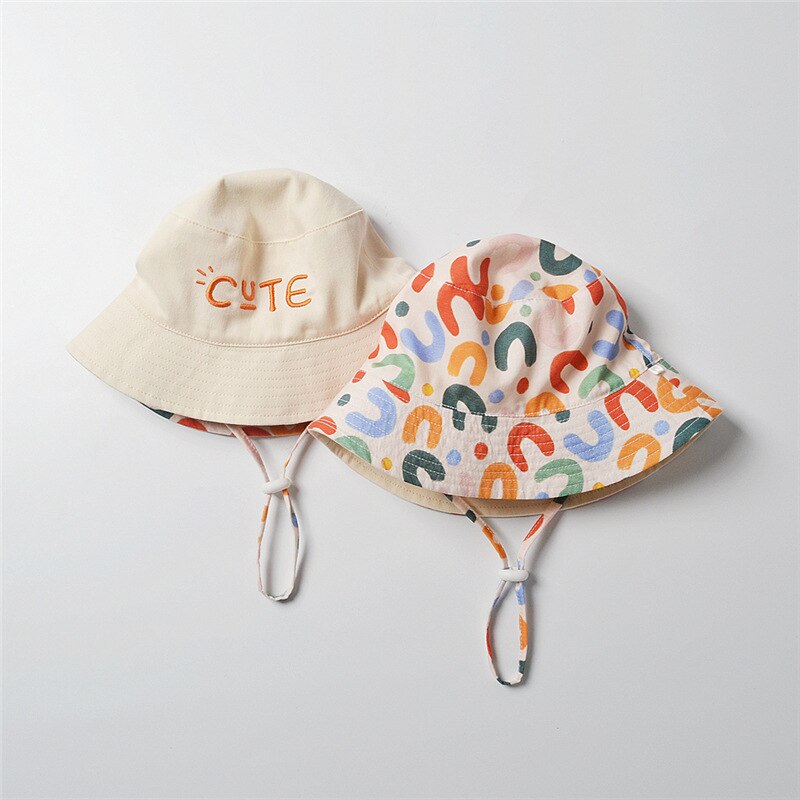 Close-up of a reversible cotton baby sun hat, showing soft fabric for infant comfort