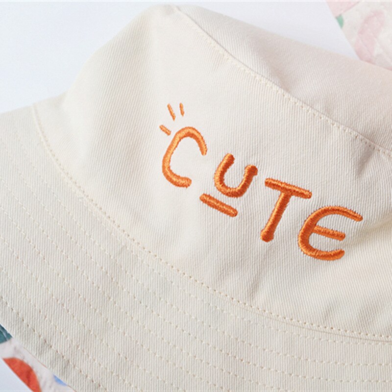 Two sides of a reversible cotton baby sun hat, offering stylish options for summer accessories