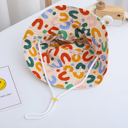 Infant cotton sun hat with chin strap, reversible design ensuring secure fit and sun safety
