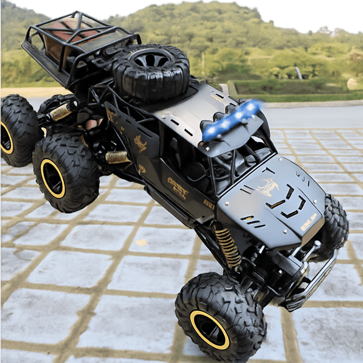 Kids playing with a ROCKSTRIKER 6x6 RC truck, enjoying all-terrain remote control adventures.
