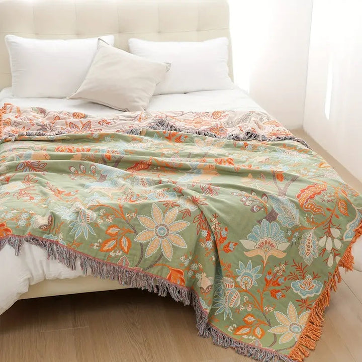 Rustic floral bohemian cotton throw blanket. Soft, machine washable & stylish home decor piece.