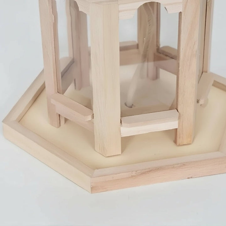 Close-up of a rustic wooden birdhouse showing the detailed craftsmanship & integrated water feature.