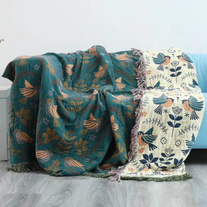 Cozy reversible throw blanket featuring a unique Scandinavian bird pattern, high-quality cotton.