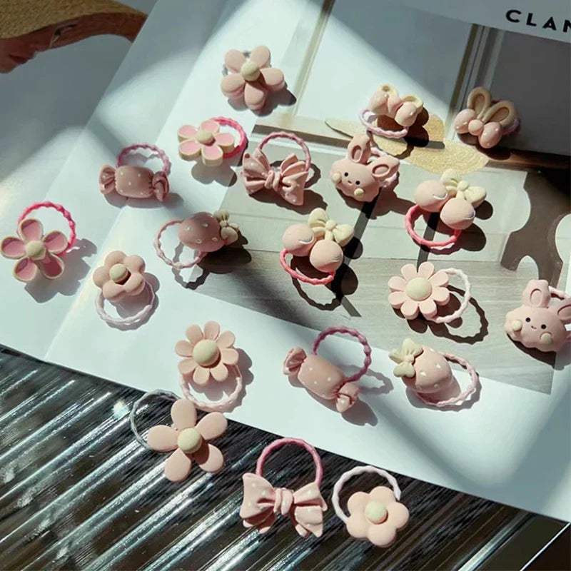 Organized display of 20 elastic cartoon hair ties, ready to be used as charming kids' hair accessories.