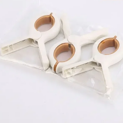 Multi-purpose bright stroller clips securing a baby blanket, great for mosquito nets and nursing covers