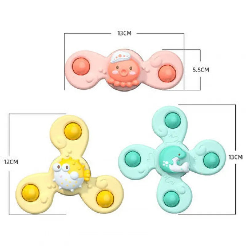 Colorful suction cup spinner toys adhering to a smooth surface, designed for baby's bath entertainment