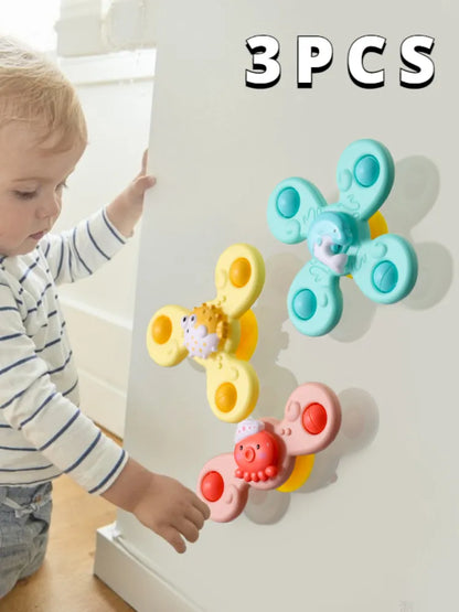 Assorted baby suction cup spinner toys in red, yellow, and blue, ideal for engaging bathtime activity
