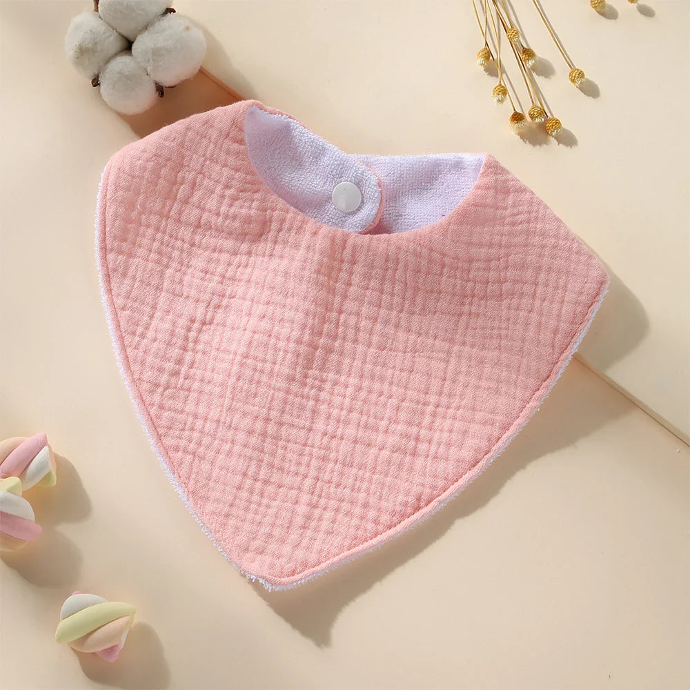 Baby wearing a waterproof muslin cotton bib, showcasing its comfortable fit & nursing functionality.