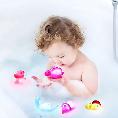 Set of colorful LED light-up dinosaur bath toys for kids' playtime, floating in water