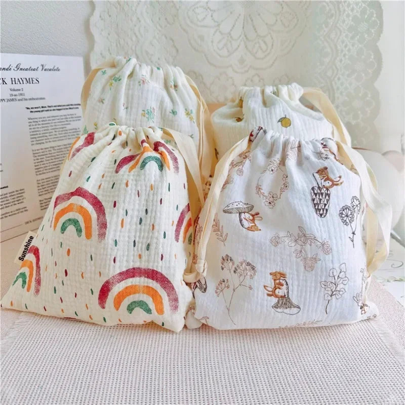 Set of natural cotton mommy storage bags for baby accessories, eco-friendly drawstring pouches.