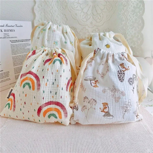 Set of natural cotton mommy storage bags for baby accessories, eco-friendly drawstring pouches.