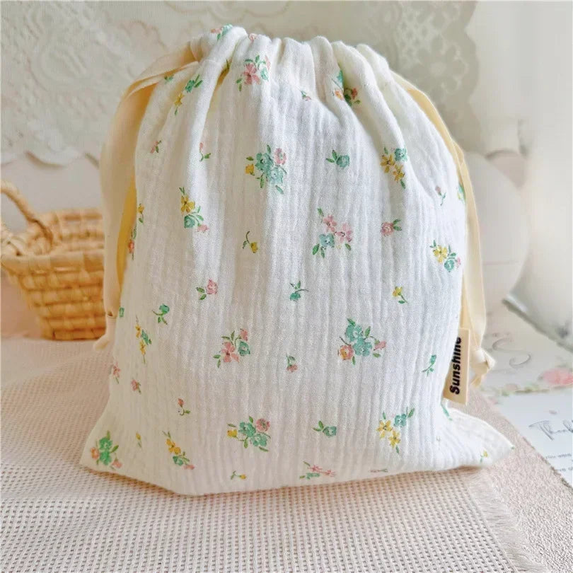 Drawstring cotton storage bag for baby essentials, eco-friendly and reusable design.