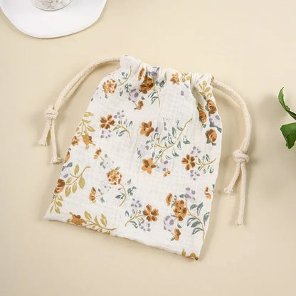 Set of different sized natural cotton bags for baby storage, eco-friendly travel organizers.