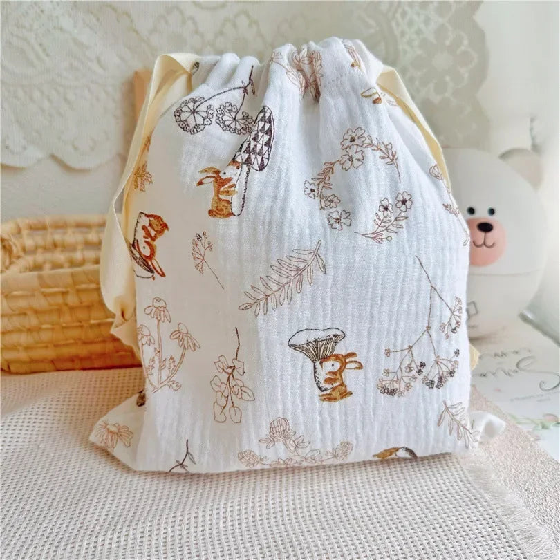 Close view of the texture on a natural cotton mommy storage bag with drawstring.