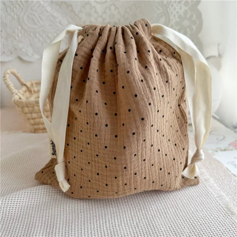 Natural cotton patterned pouch, excellent for organizing small baby accessories in nursery or travel.