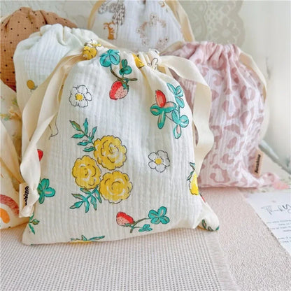 Assorted sizes of natural cotton drawstring bags, versatile baby accessories and organizers.