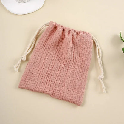 Natural cotton baby accessories organizer, drawstring pouch design for easy access.