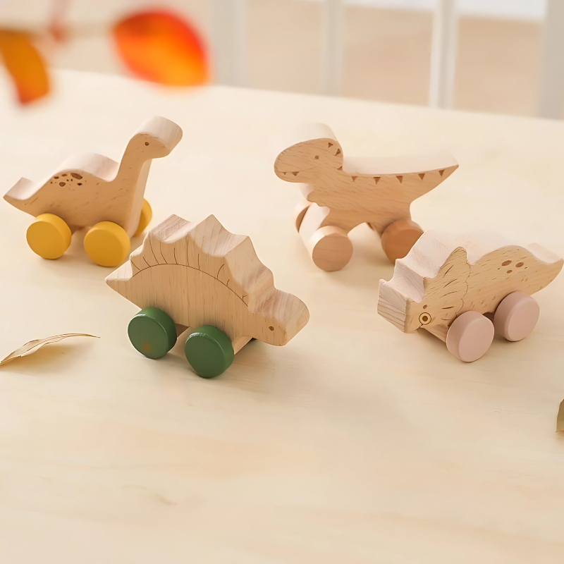Set of wooden dinosaur roller cars for kids, promoting motor skills and imaginative play.