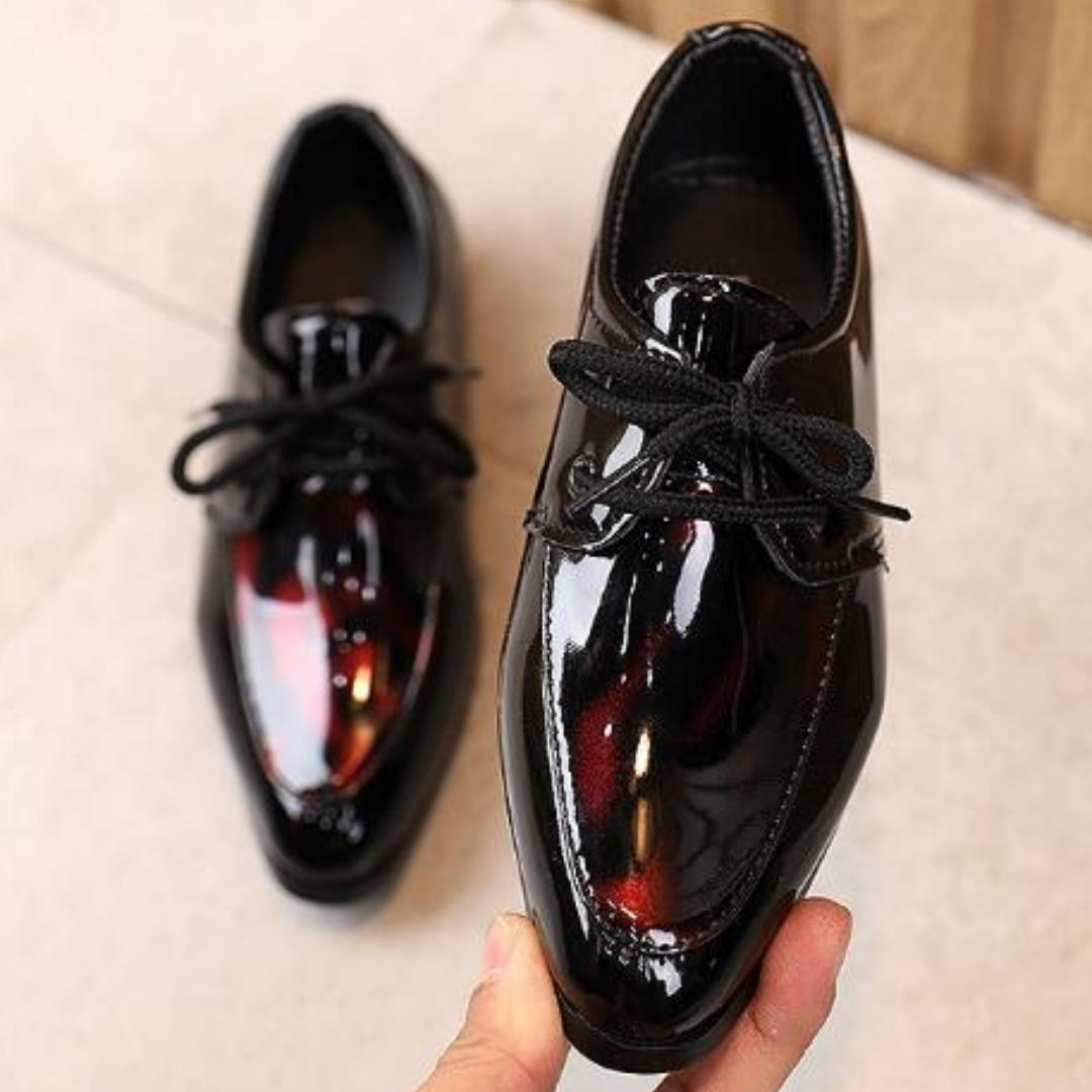 Shiny black pointy toe slip-on dress shoes for boys, perfect for formal occasions