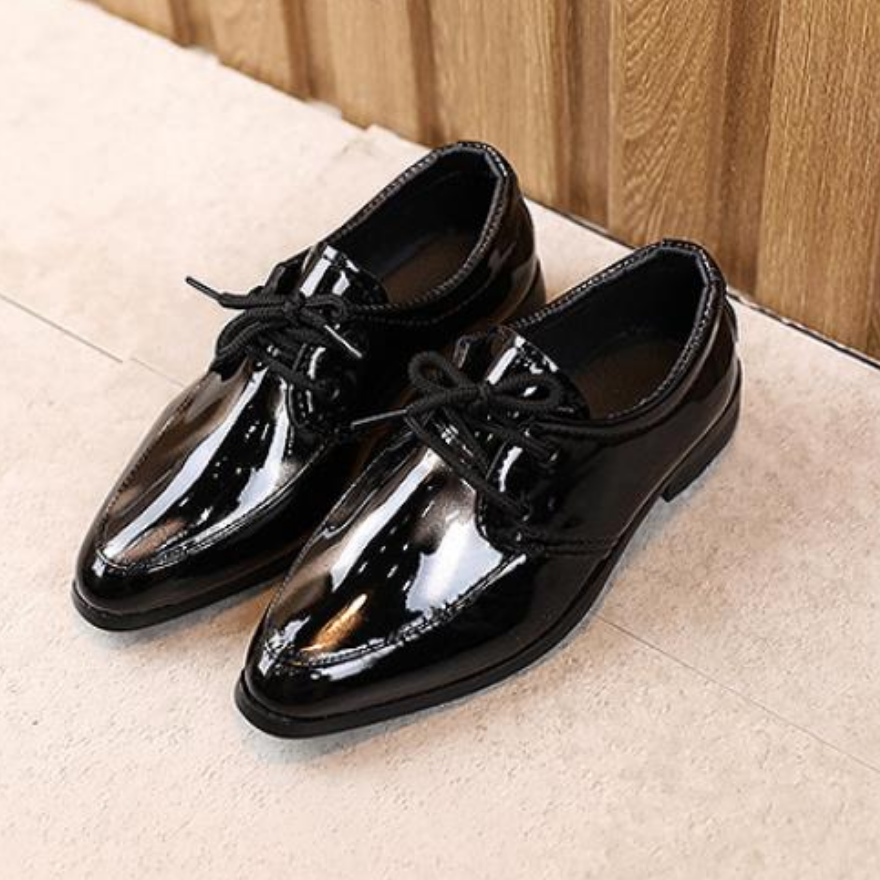 Elegant boys' black leather dress shoes, slip-on style with a distinctive pointy toe
